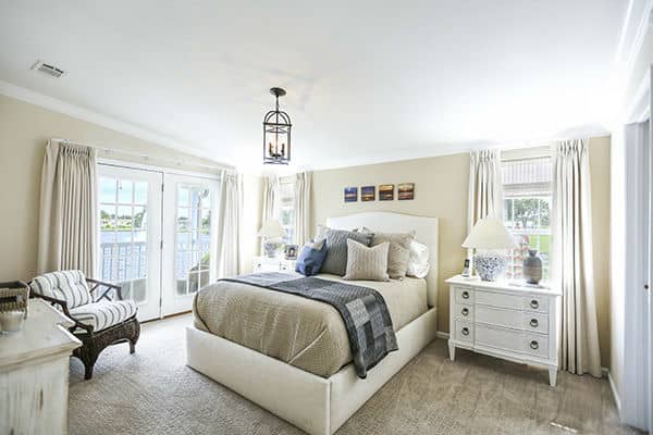 Rexmere Luxury series bedroom with French doors that have views of the Lake Rexmere.