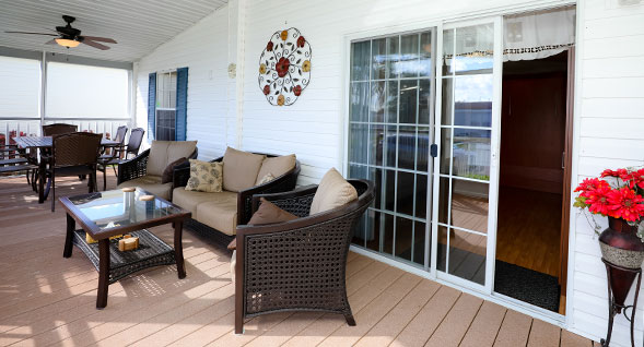 Beautiful enclosed screened in porch with ceiling fan and light for true south florida outdoor living