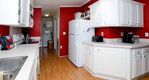 Punchy kitchen with bright red walls and utility room including full sized washer dryer