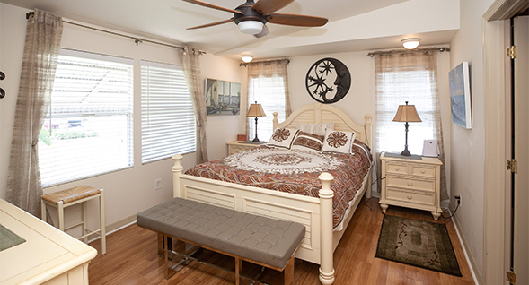 Lovely master bedroom features lots of windows and hardwood laminate flooring