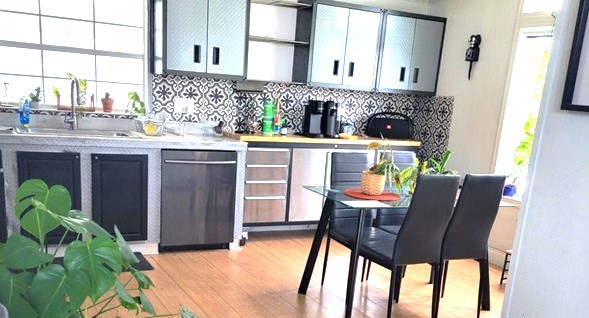 beautiful stylish kitchen with vaulted ceilings in artistic decorator colors.