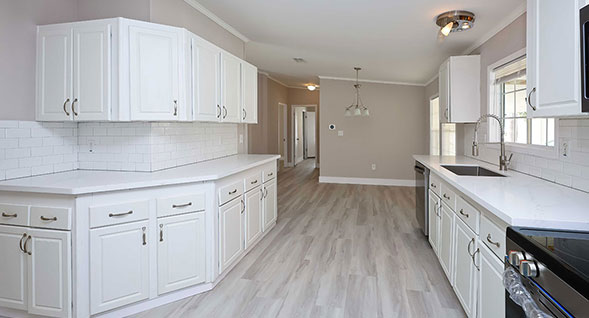 Beautiful galley kitchen with high end appliances including side-by-side refrigerator with door through ice, dishwasher, smooth top range and built in