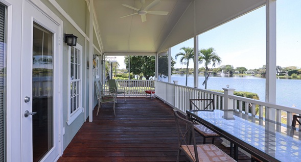 Expansive screened lakefront veranda at Silverwater Sanctuary offering breathtaking open-water views and elegant outdoor living in Rexmere Village.