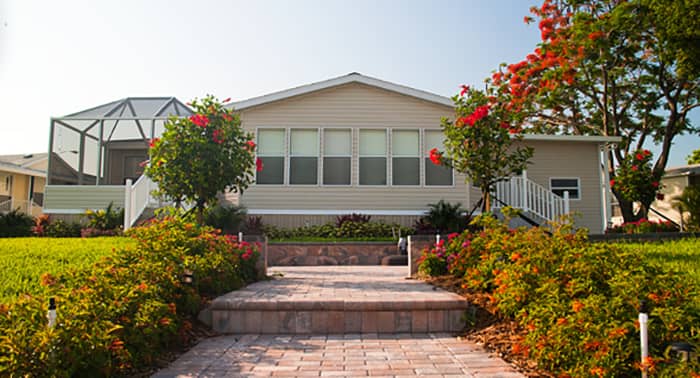 Beautiful pre-built home with brick walk way and large enclosed outdoor porch